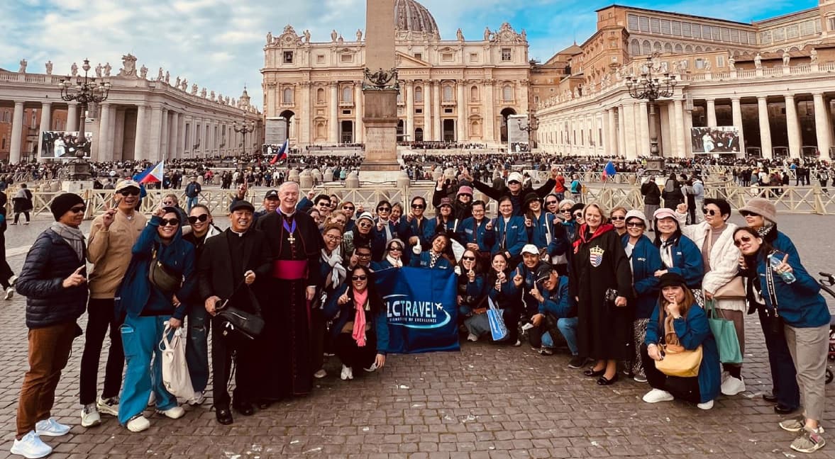 A diverse group of happy travelers posing for a photo in a beautiful travel destination